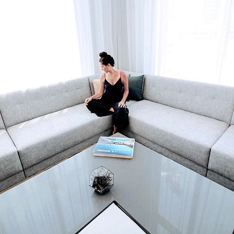 woman sitting on the couch in the Cambria Hotel in Los Angeles