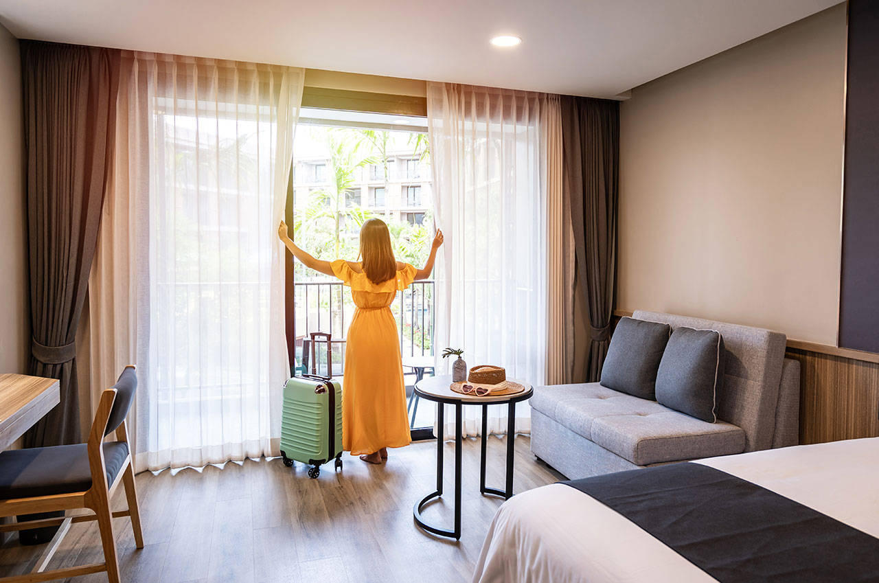 woman enjoying the view from her room